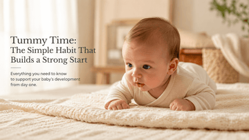 Newborn baby lifting their head during tummy time on a soft organic cotton blanket, warm natural light in a minimalist nursery