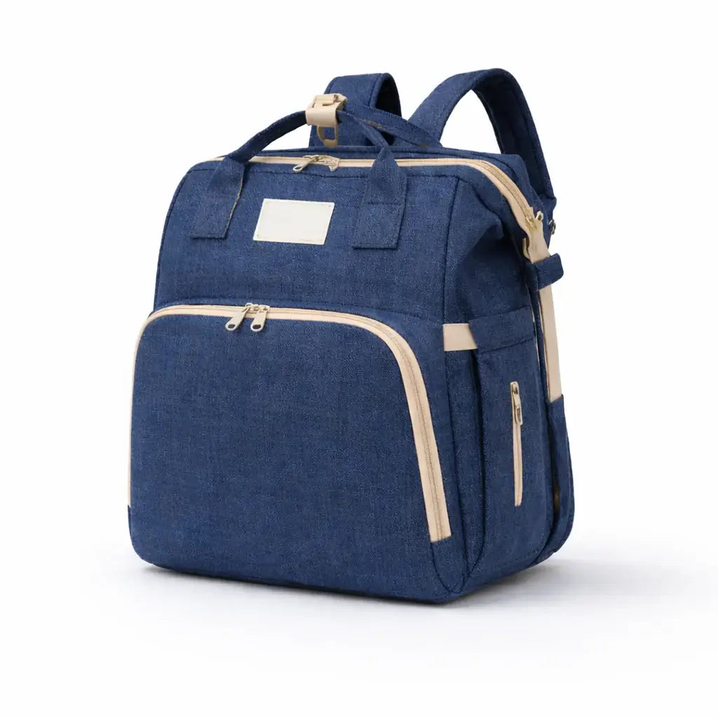 The All-In-One Diaper Bag Blue backpack with beige accents on a white background