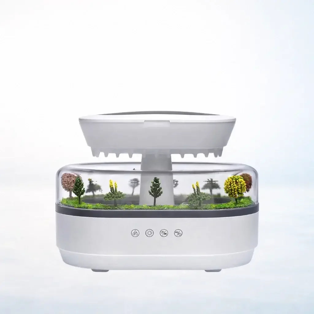 Aroma raindrop humidifier with miniature tree landscape in transparent compartment, white background