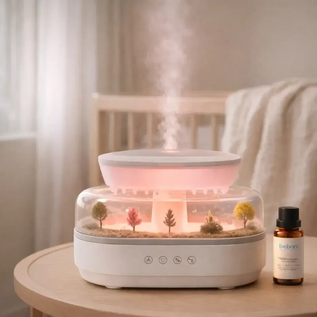 Pink aroma raindrop humidifier with miniature trees and essential oil bottle on a table
