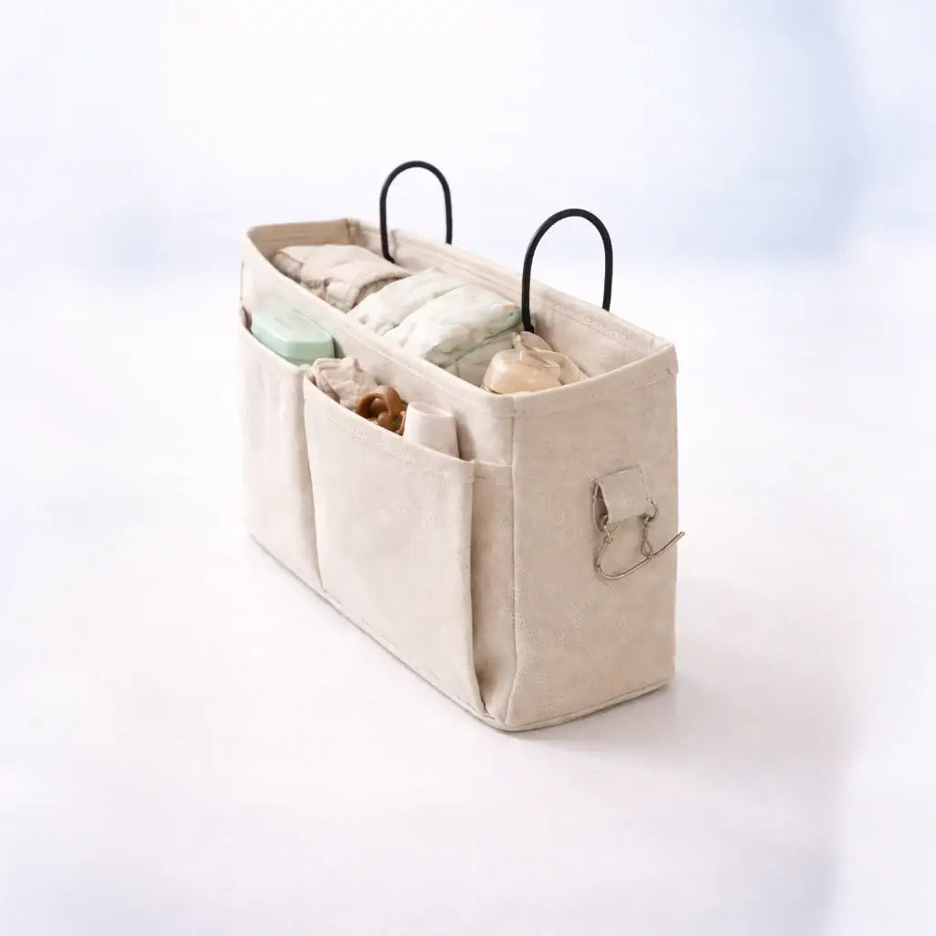 Bedside Baby Organiser – Beige fabric caddy with black handles on a white background
