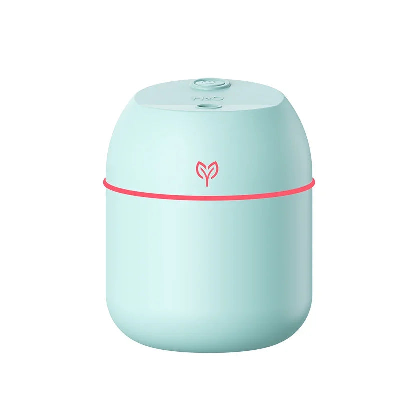 mini usb humidifier diffuser in mint green with red accent detail, compact design shown on a white background for small space use.