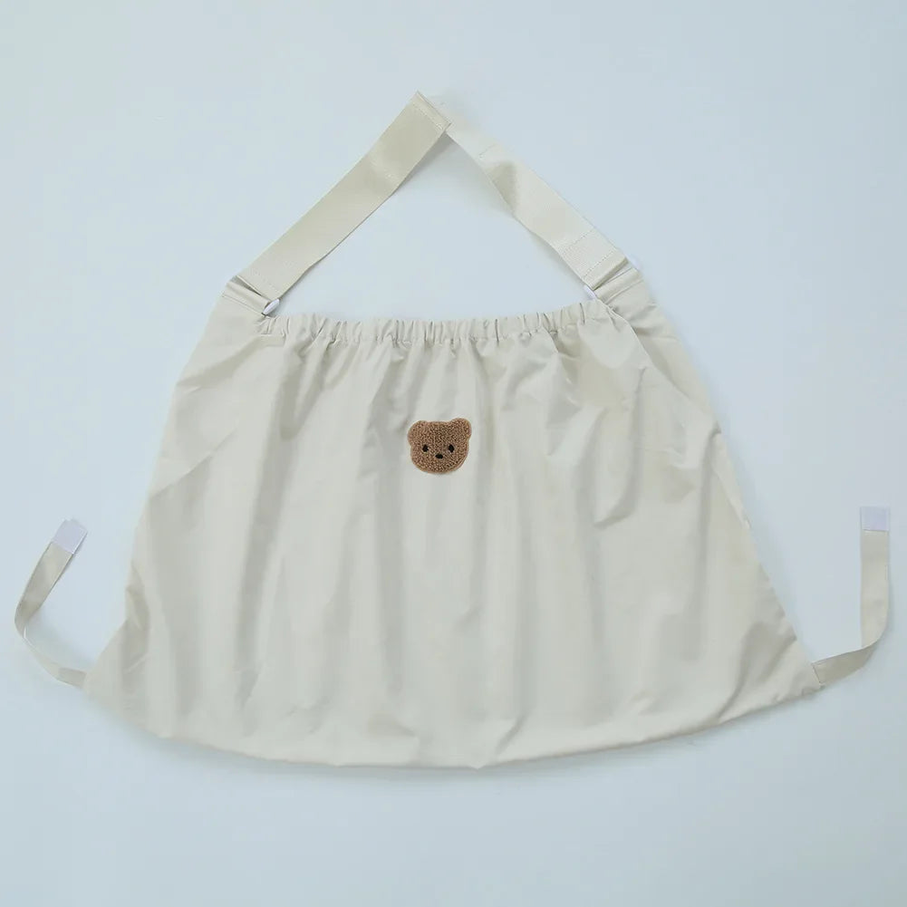 Reusable Stroller Pouch - Cream apron with adjustable straps and cute brown bear face embroidery on the front