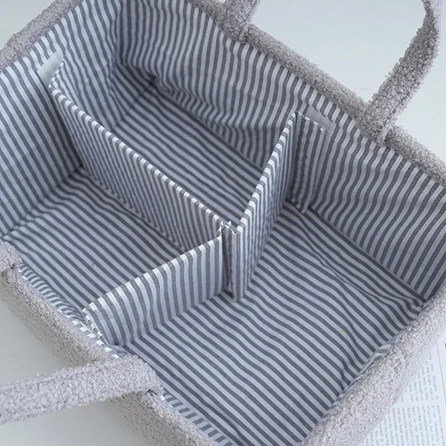 Striped fabric tote bag with handles and interior dividers for storage organization