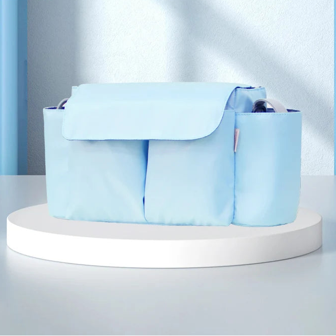 Light blue stroller organizer with large capacity and multiple compartments, designed for organizing baby essentials on the go.