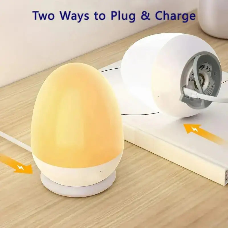 Portable touch egg lamp shown with dual plug and charge options on a wooden surface.