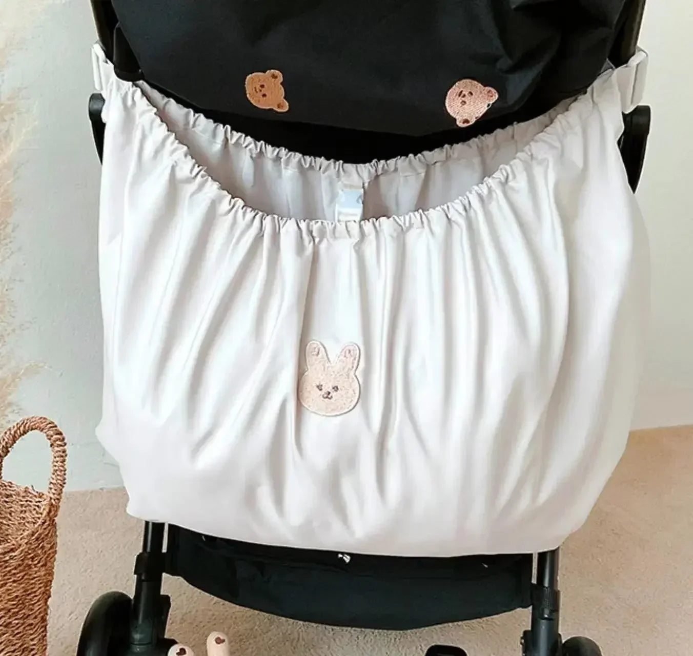 Reusable Stroller Pouch - Stroller organizer cover with cute bear and bunny face embroidery, attached to stroller.