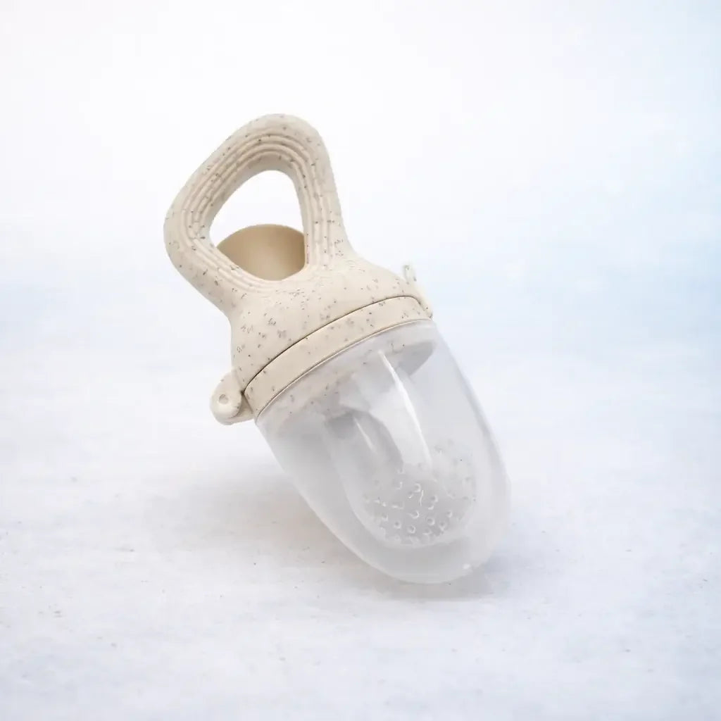 Silicone baby fruit feeder in coffee color with textured handle on white background