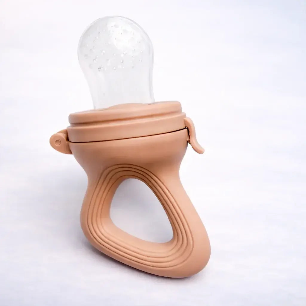 Brown silicone baby fruit feeder pacifier with ergonomic handle on white background