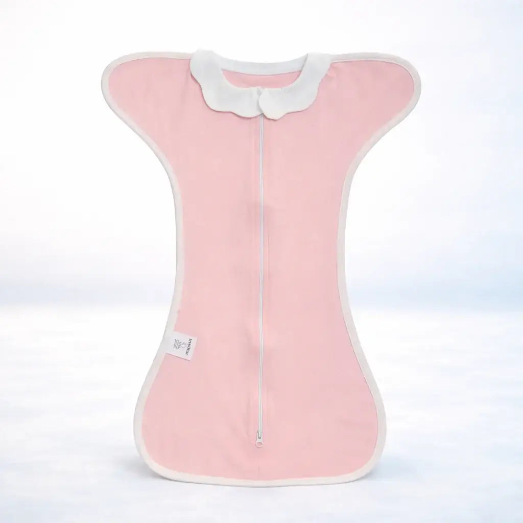 The Sleep Nest - Pink newborn sleep sack with white edges, featuring a dual-use design for nursing and baby wrapping. Made of breathable cotton.