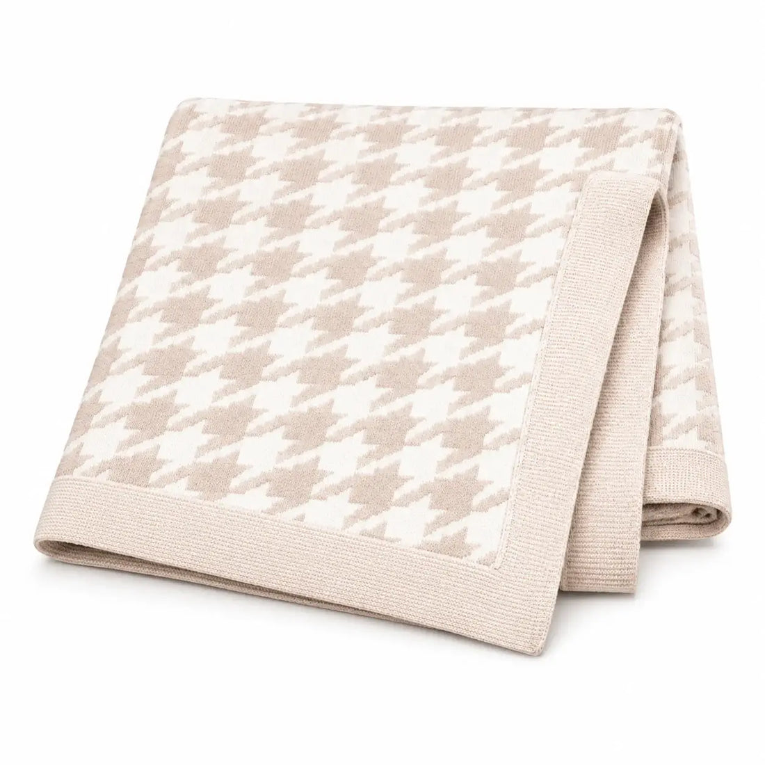 Folded beige quilt with a subtle pattern on a white background