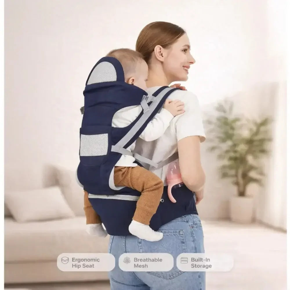 Mother carrying baby in ergonomic navy blue adjustable baby carrier with breathable mesh and hip seat, indoors
