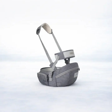 Gray ergonomic baby hip seat carrier with adjustable straps and zippered pockets on white background