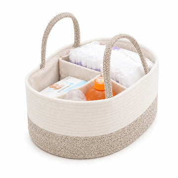 Beige woven baby caddy with diapers, wipes, and a bottle on a white background