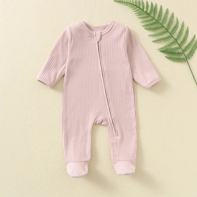 Pink Organic Ribbed Zip Baby Romper for soft, breathable everyday wear with an easy one-piece design and delicate comfort for infants.