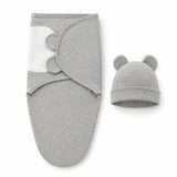 Adjustable cotton swaddle and matching bear-eared hat in soft gray fabric.