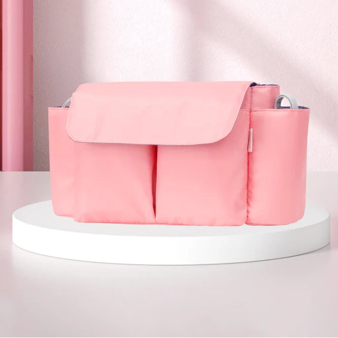 Stroller organizer in pink with spacious compartments for baby essentials, designed for large capacity smart storage.