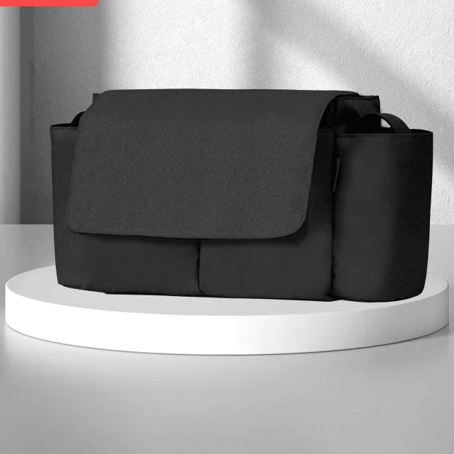 Black stroller organizer with large capacity, featuring multiple compartments. Designed for convenience and efficiency during outings.