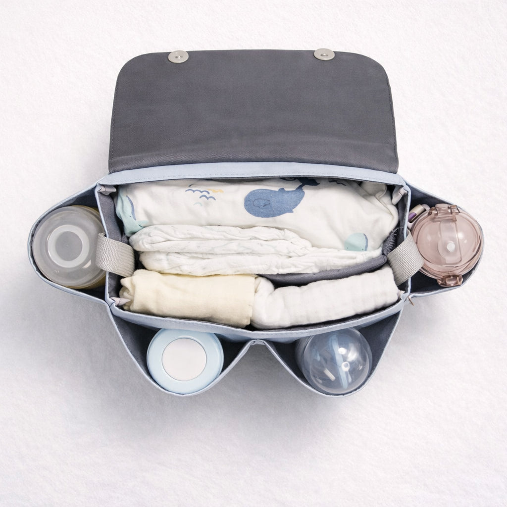 Stroll Station - Open stroller organizer showing spacious multi-compartment design with baby essentials neatly arranged inside.