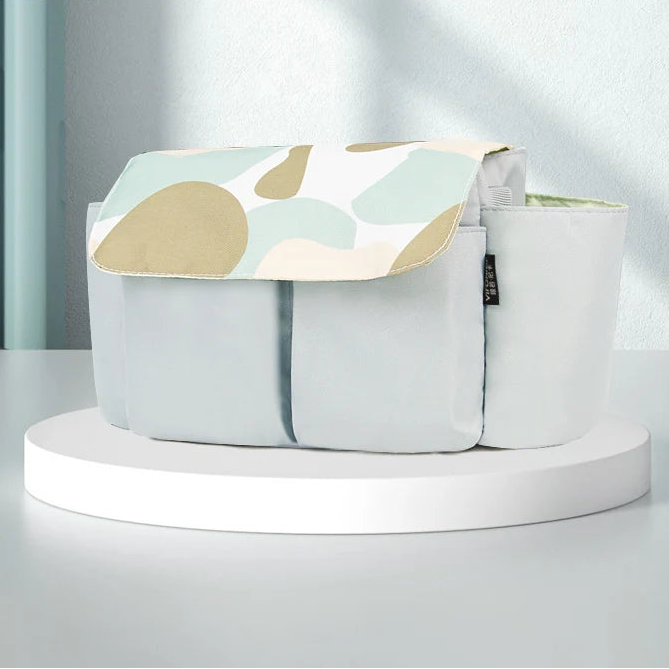 Stroller organizer with large capacity featuring a stylish design on a white platform, perfect for keeping baby essentials organized.