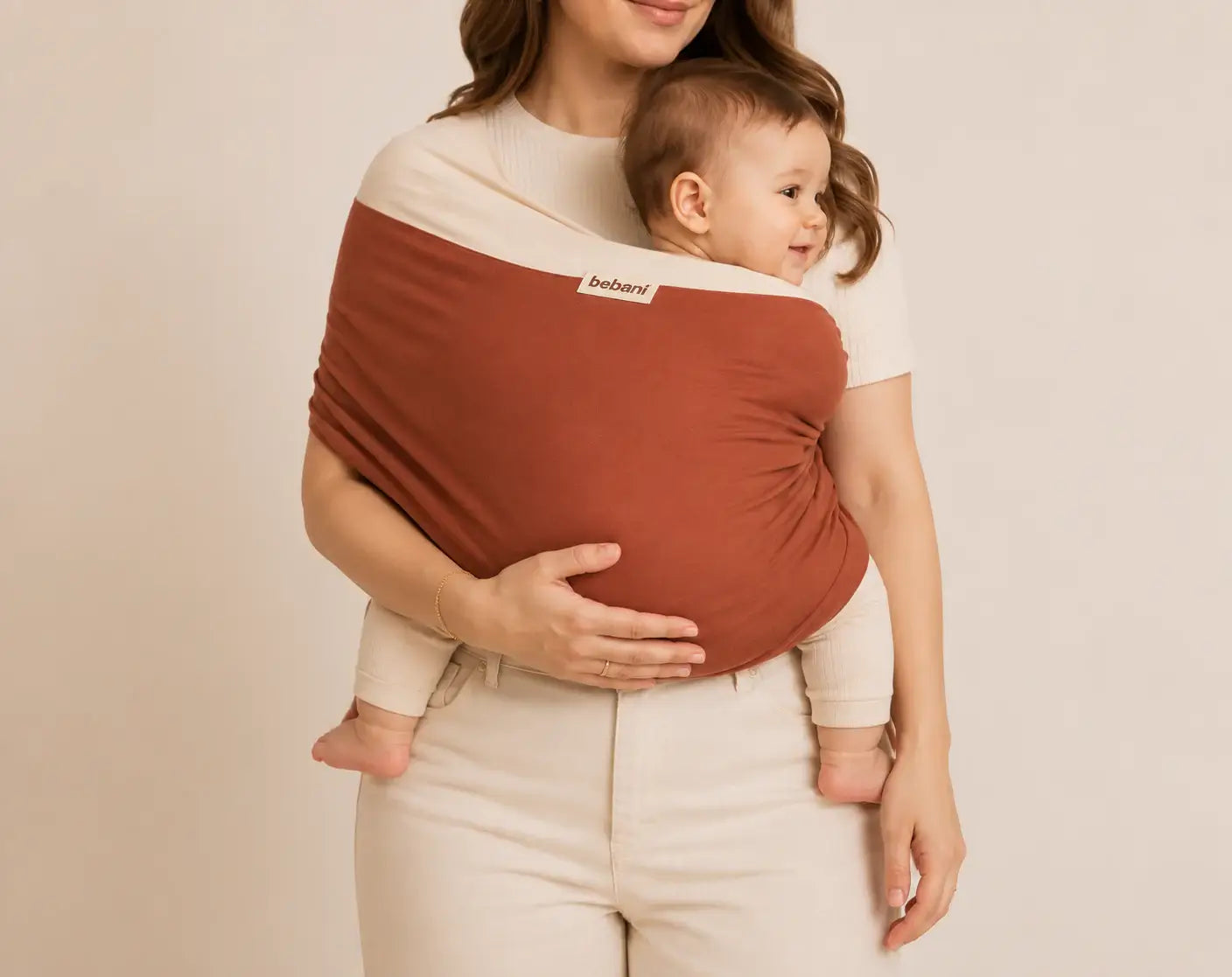 A parent using The Baby Wrap™ baby wrap carrier to hold their child comfortably, promoting bonding and security.